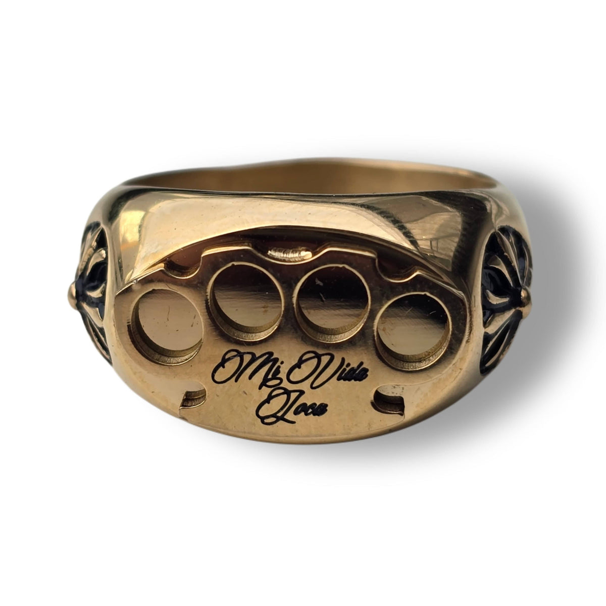 Gold MVL Logo ring from the front with MVL logo and Mi Vida Loca engraving