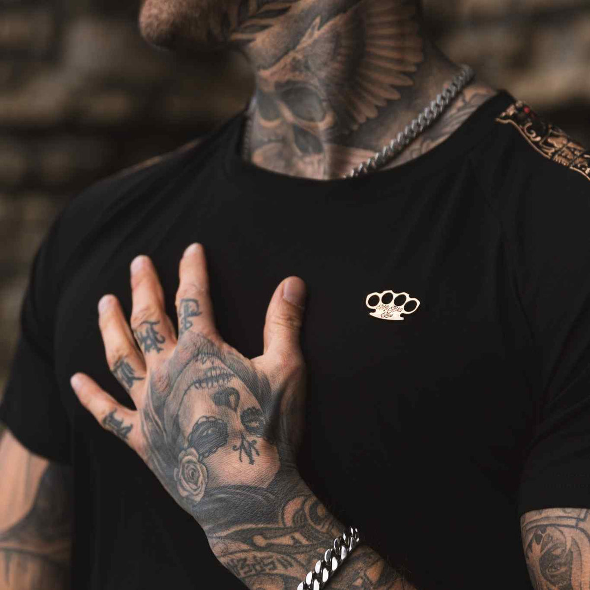 Close-up of the black LFR T-shirt worn, with gold MVL logo on the chest