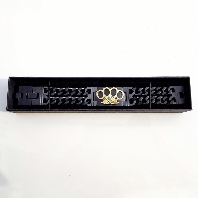 MVL bracelet in black/gold in the open long black box on a white background