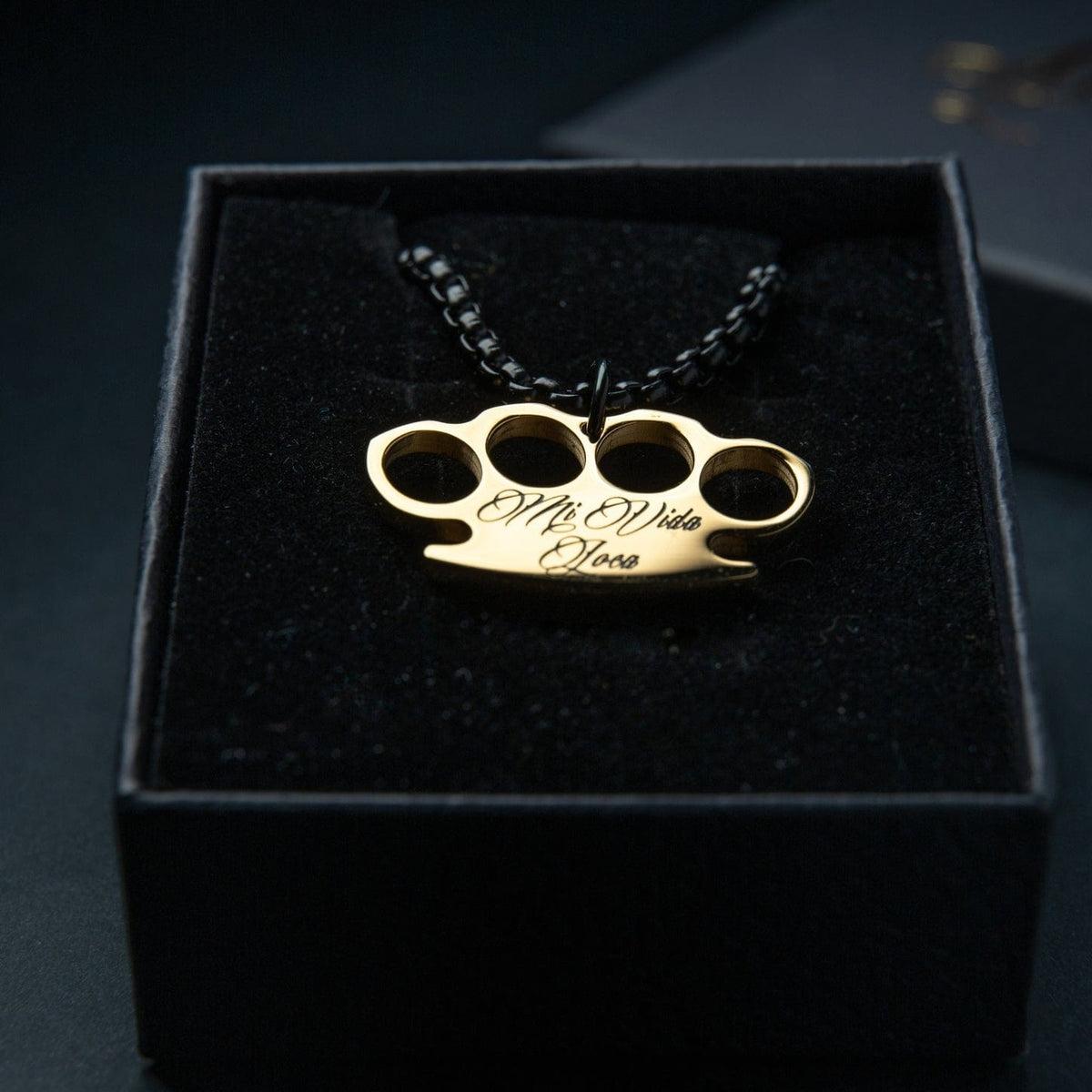 Mi Vida Loca Logo chain Black / Gold with gold MVL logo pendant on a black chain in the box