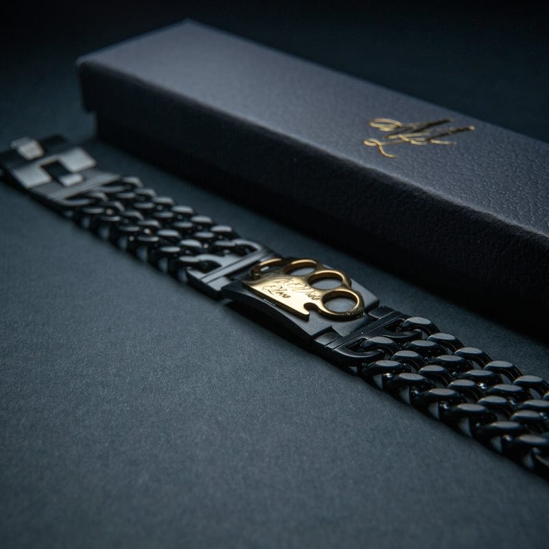 Mi Vida Loca bracelet in black/gold, black link bracelet with gold MVL logo next to the black box