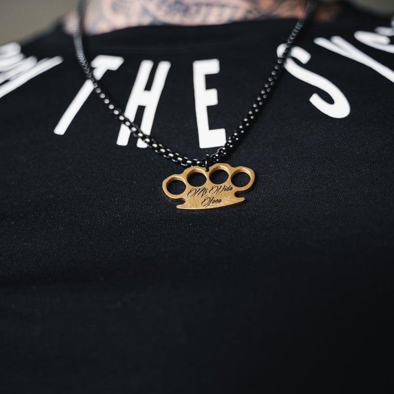 Black MVL Logo chain with gold MVL logo pendant worn on a black T-shirt