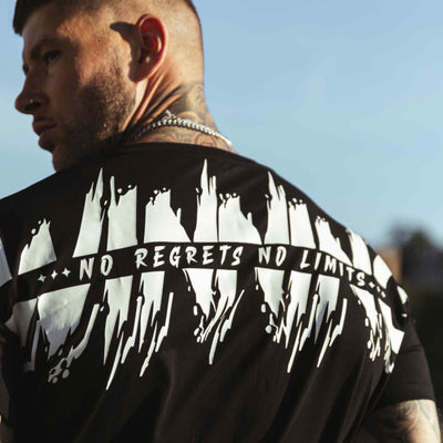 Close-up of the white No regrets no limits print on the back of the black Winning T-shirt